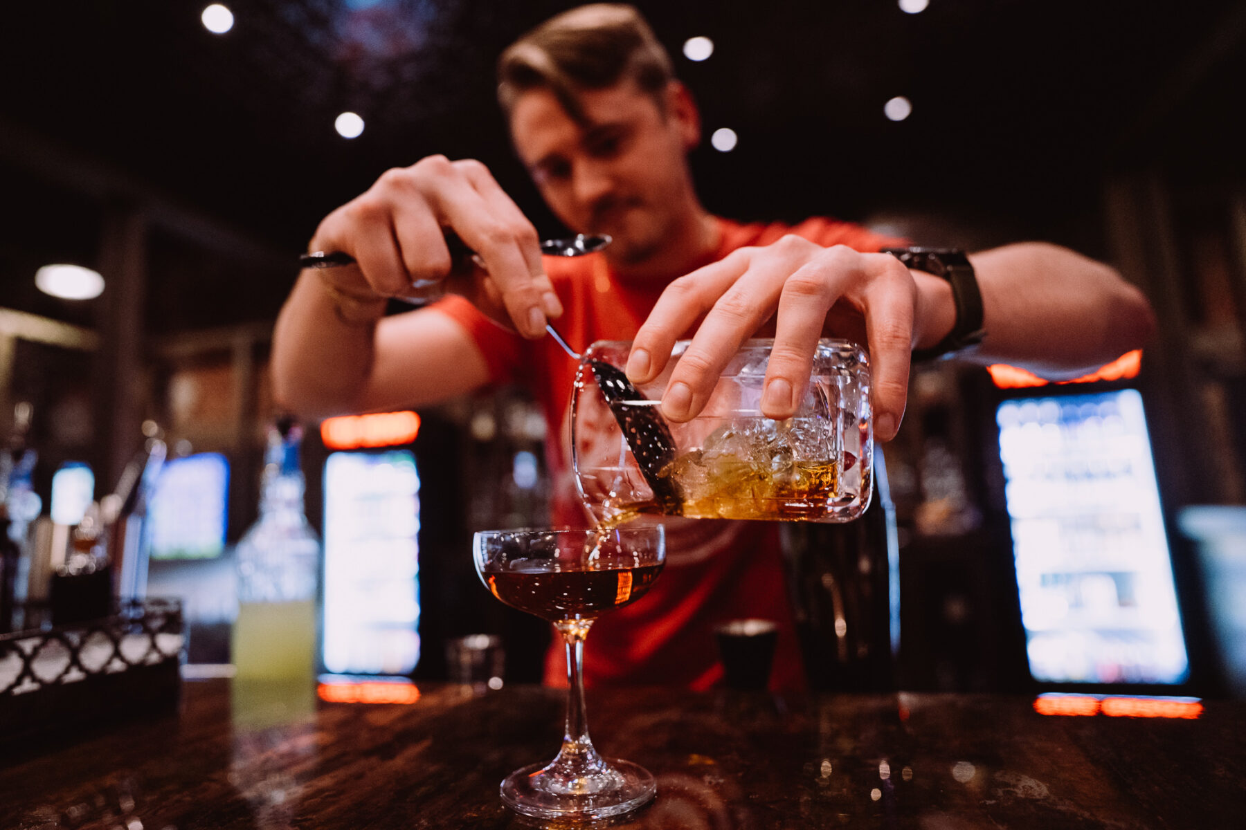 One of our expert bartenders makes a craft cocktail for a guest